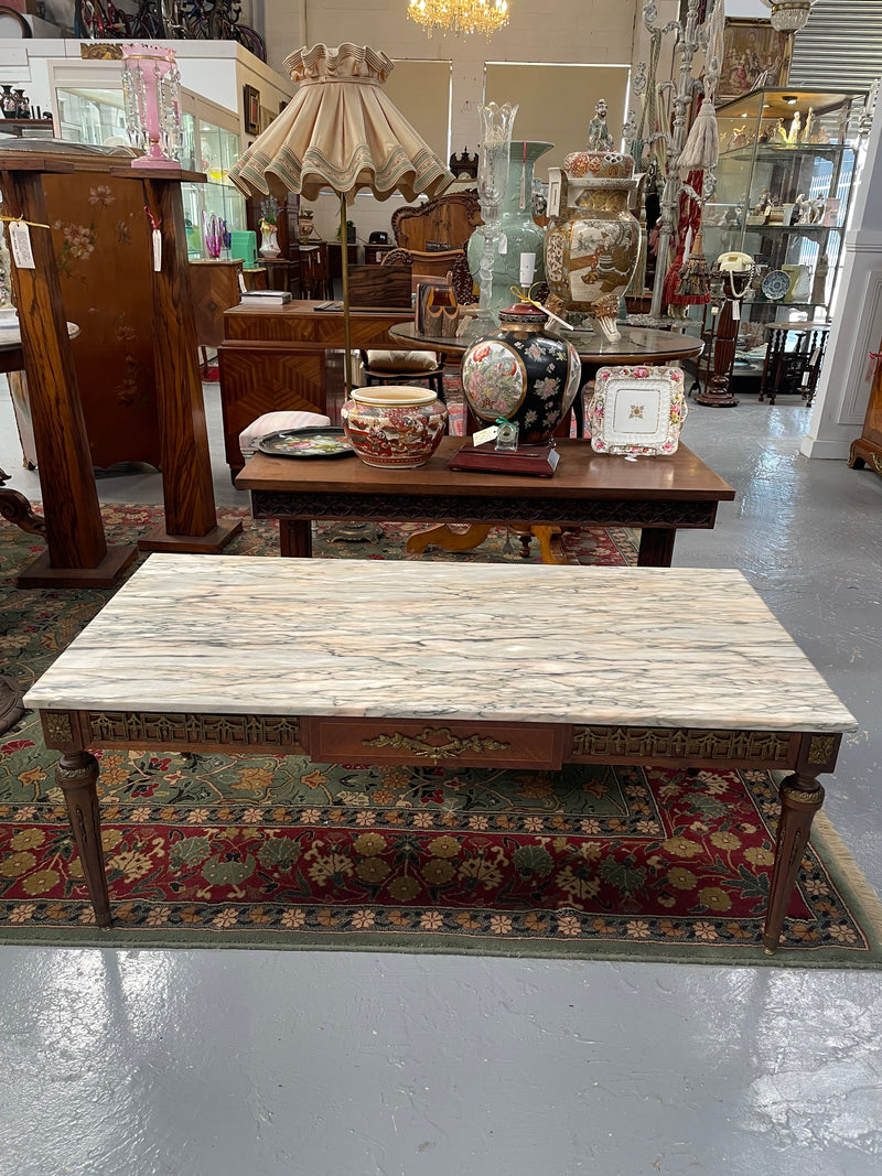 Impressive Louis XVI style walnut coffee table. Stunning marble top, gilt mounts and fluted legs. Circa: 1950's. In good original condition.