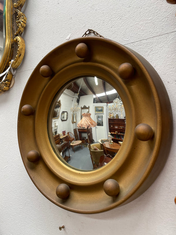 An elegant compact round convex wall mirror with lovely details that has been sourced directly from France. It is in good original condition. Please see photos as they form part of the description and condition.