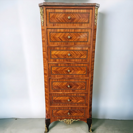 Louis XVI style French Kingwood and Rosewood inlaid semainier with a beautiful and practical marble top. Plenty of storage space with seven drawers. Also features elegant gilt mounts and decorative inlay. It has been sourced from France and is in good original detailed condition