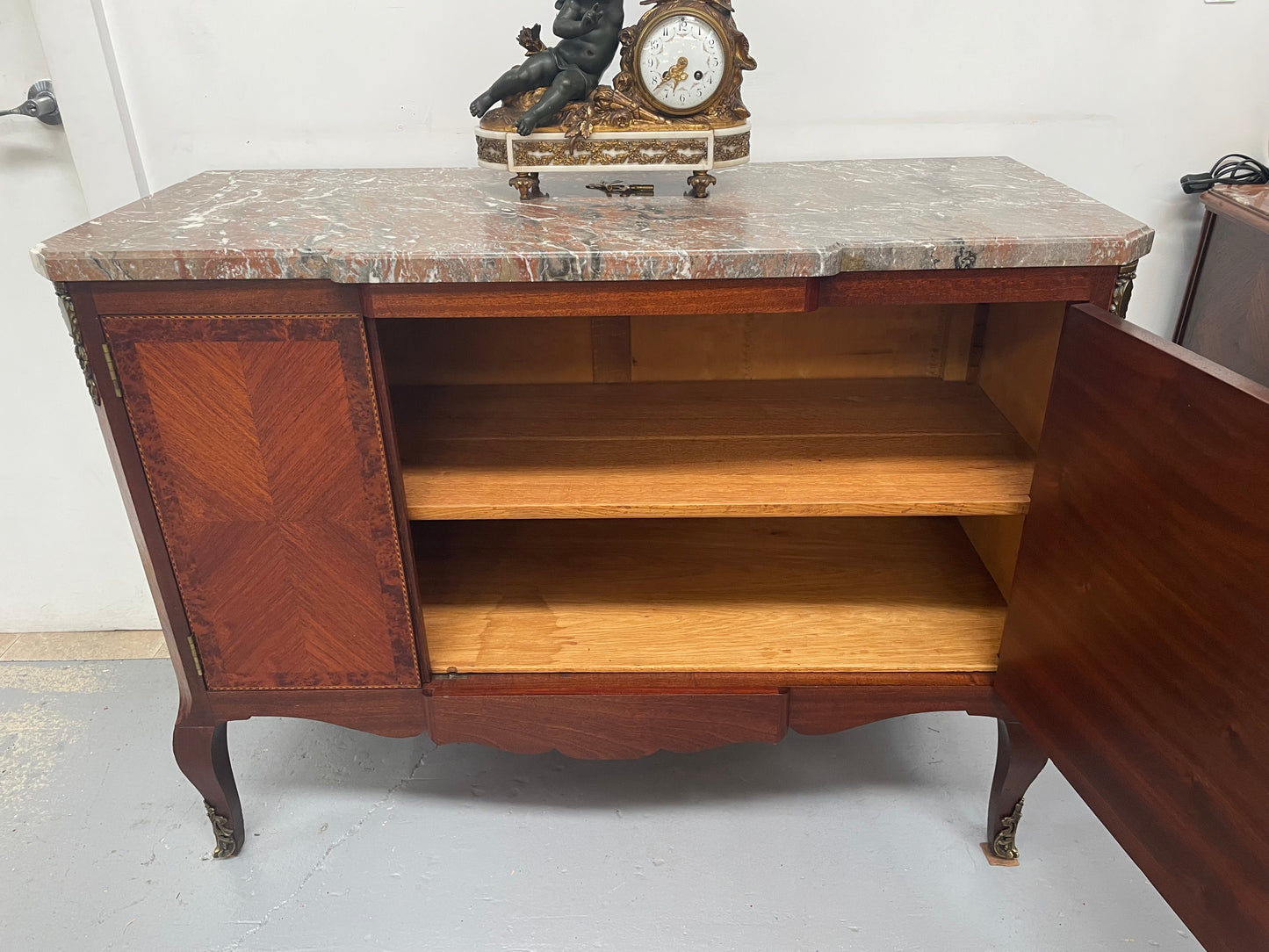 Antique late 19th century Transitional style marble top cabinet featuring beautiful marquetry inlay and decorative mounts. In good original detailed condition. 