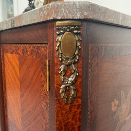 Antique late 19th century Transitional style marble top cabinet featuring beautiful marquetry inlay and decorative mounts. In good original detailed condition. 
