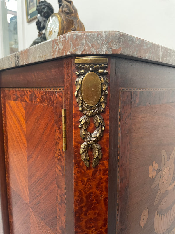 Antique late 19th century Transitional style marble top cabinet featuring beautiful marquetry inlay and decorative mounts. In good original detailed condition. 