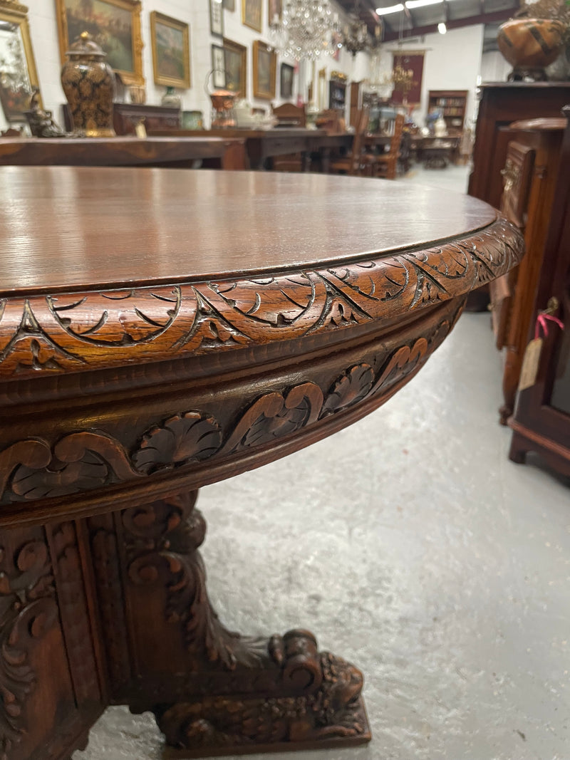 Antique French Oak renaissance style round centre table. Featuring amazing detailed carving to base and throughout. Sourced from France and in good original detailed condition.