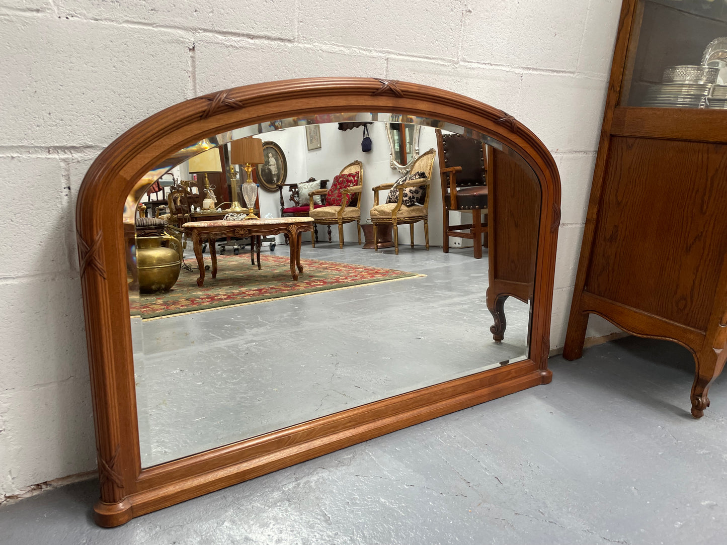 French walnut Art Deco style mantle mirror. Beautiful decorative carvings and still has its original bevelled edge mirror. Sourced directly from France and in good original condition with mirror showing some age. 