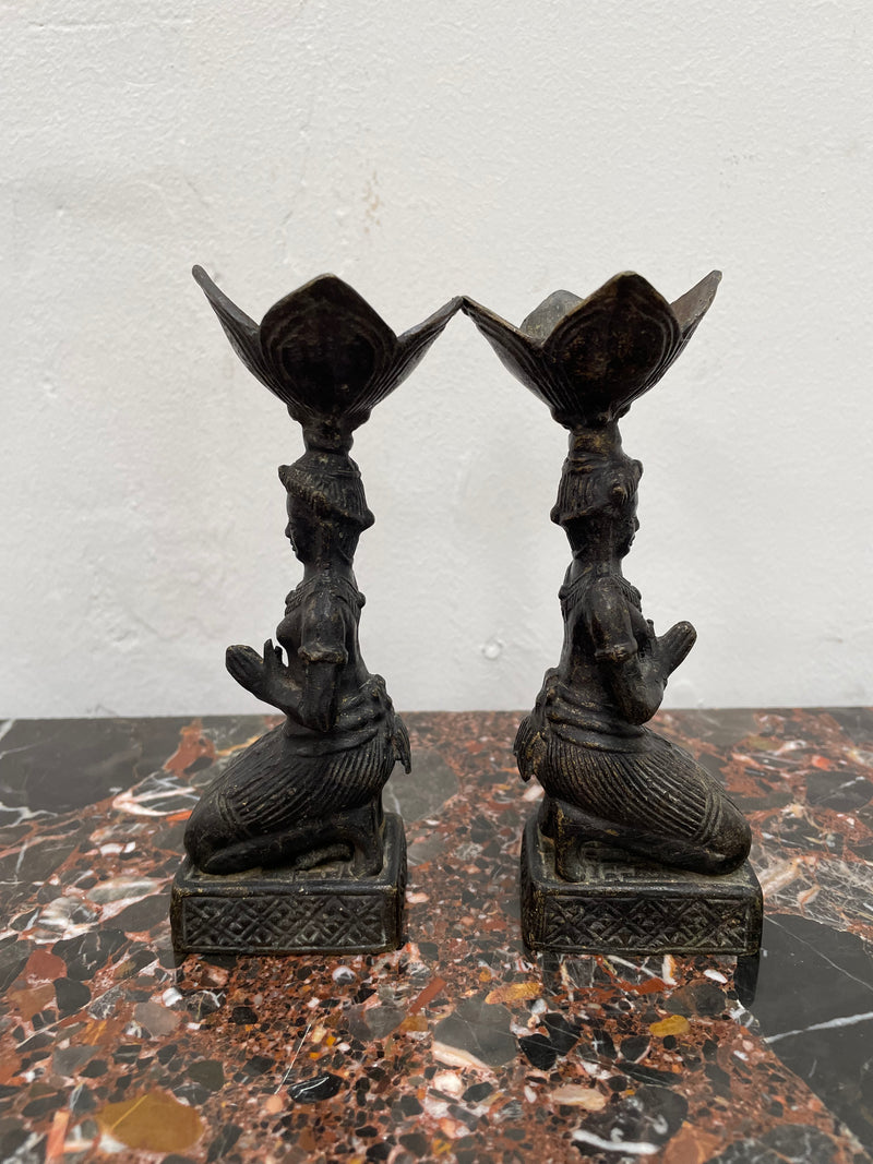 Pair of Thai Antique bronze dark patinated candle holders. They are in good original condition with some signs of age.