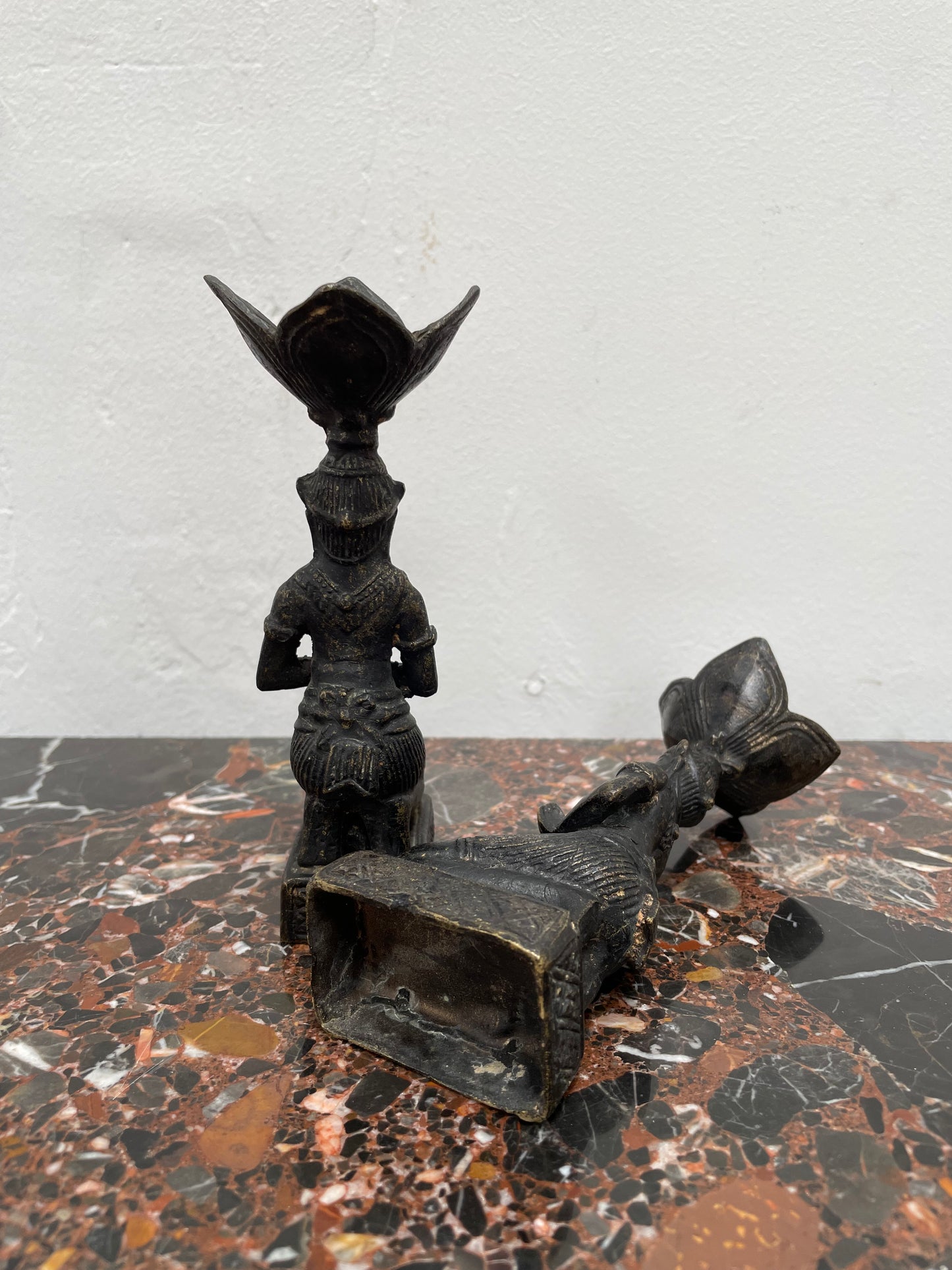 Pair of Thai Antique bronze dark patinated candle holders. They are in good original condition with some signs of age.