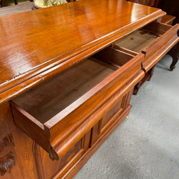 Cedar cupboard / side cabinet with two drawers above a pair of figured paneled doors, decorated with two corbels and on a plinth base. In good original condition and sourced locally.