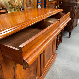 Cedar cupboard / side cabinet with two drawers above a pair of figured paneled doors, decorated with two corbels and on a plinth base. In good original condition and sourced locally.