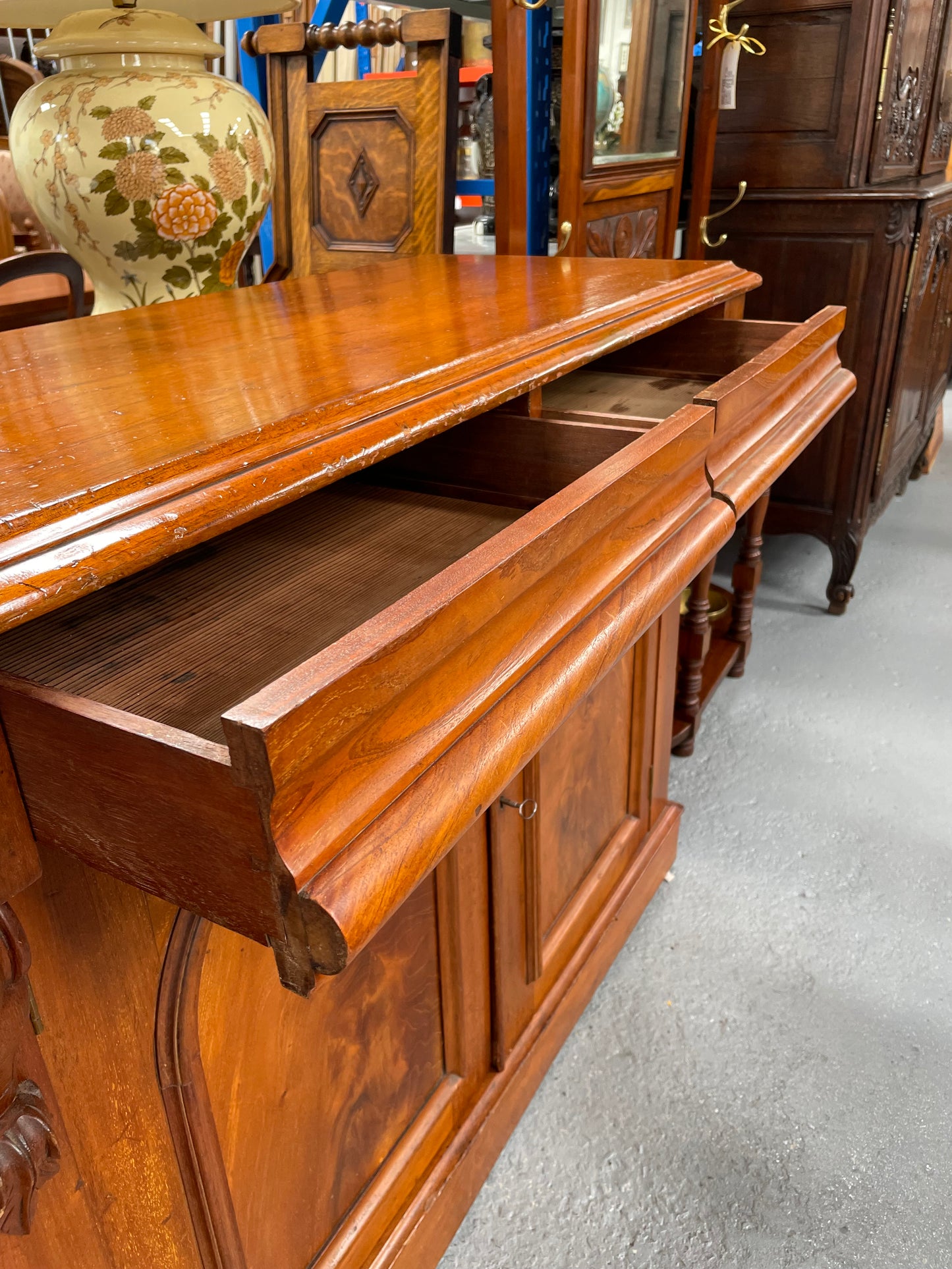 Cedar cupboard / side cabinet with two drawers above a pair of figured paneled doors, decorated with two corbels and on a plinth base. In good original condition and sourced locally.