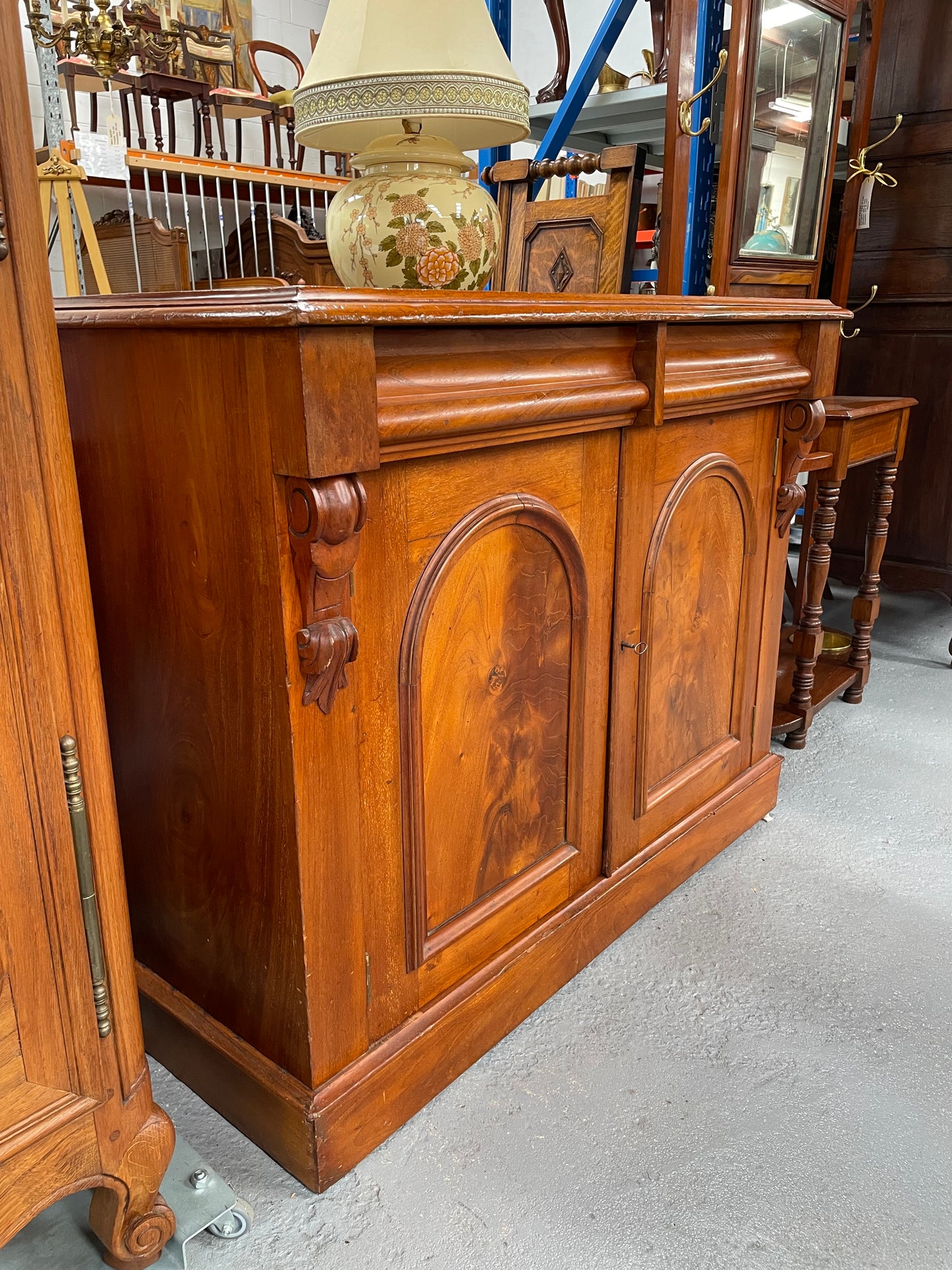 Cedar cupboard / side cabinet with two drawers above a pair of figured paneled doors, decorated with two corbels and on a plinth base. In good original condition and sourced locally.