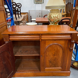 Cedar cupboard / side cabinet with two drawers above a pair of figured paneled doors, decorated with two corbels and on a plinth base. In good original condition and sourced locally.