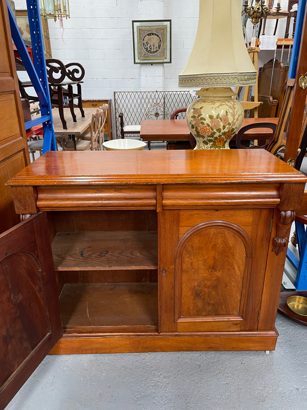 Cedar cupboard / side cabinet with two drawers above a pair of figured paneled doors, decorated with two corbels and on a plinth base. In good original condition and sourced locally.