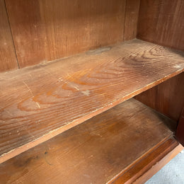 Cedar cupboard / side cabinet with two drawers above a pair of figured paneled doors, decorated with two corbels and on a plinth base. In good original condition and sourced locally.
