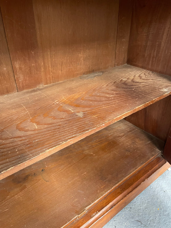 Cedar cupboard / side cabinet with two drawers above a pair of figured paneled doors, decorated with two corbels and on a plinth base. In good original condition and sourced locally.