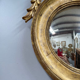 A stunning round carved wooden eagle convex hanging mirror. The eagle theme adds a touch of elegance and sophistication to your décor. It is in good as found condition.