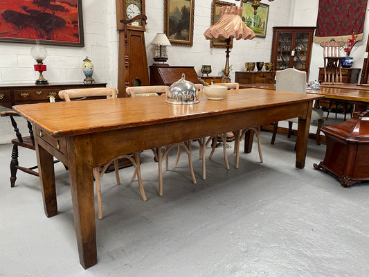 This table stands on four tapered legs supporting the main section. There are four sides with an original long drawer to each end. The top is in good condition commensurate with age and consists of three thick wide planks. The table is very strong and sturdy.