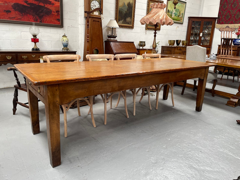 This table stands on four tapered legs supporting the main section. There are four sides with an original long drawer to each end. The top is in good condition commensurate with age and consists of three thick wide planks. The table is very strong and sturdy.