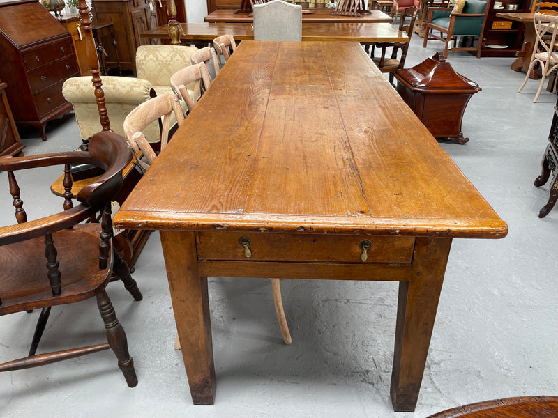 This table stands on four tapered legs supporting the main section. There are four sides with an original long drawer to each end. The top is in good condition commensurate with age and consists of three thick wide planks. The table is very strong and sturdy.