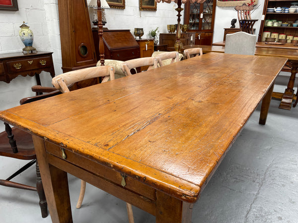 This table stands on four tapered legs supporting the main section. There are four sides with an original long drawer to each end. The top is in good condition commensurate with age and consists of three thick wide planks. The table is very strong and sturdy.