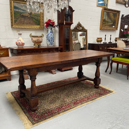 Solid charming rustic French farmhouse table with a stretcher base and turned legs. Imported directly from France and is circa 1930's. In good original detailed condition.