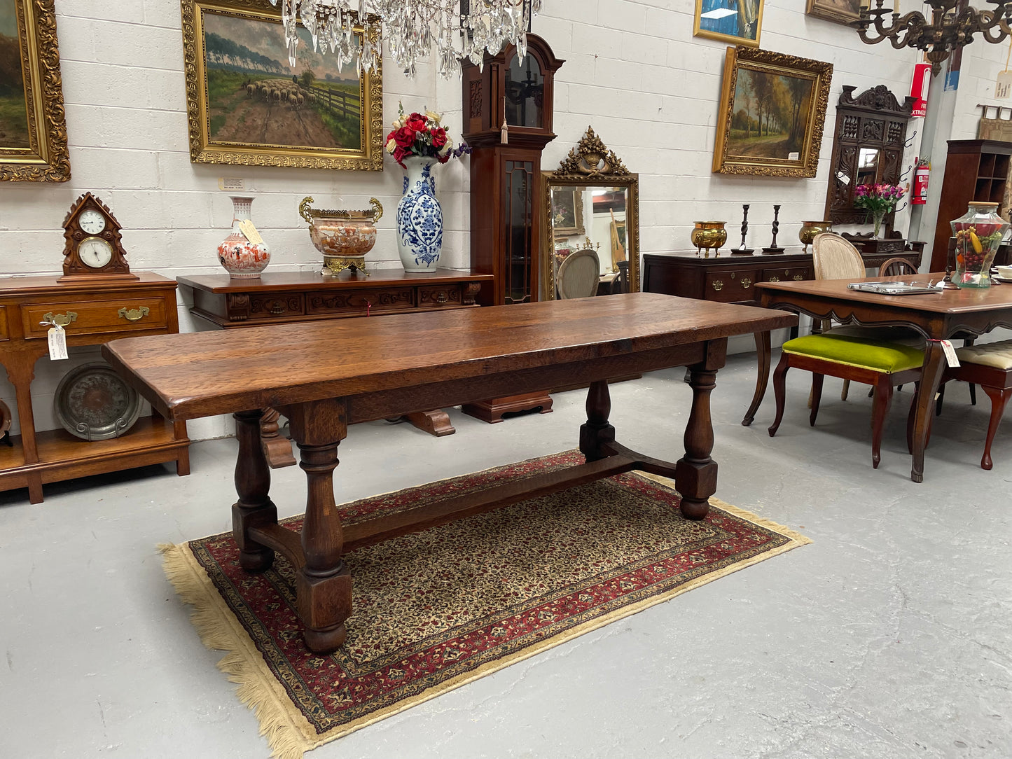 Solid charming rustic French farmhouse table with a stretcher base and turned legs. Imported directly from France and is circa 1930's. In good original detailed condition.