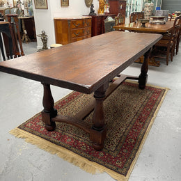 Solid charming rustic French farmhouse table with a stretcher base and turned legs. Imported directly from France and is circa 1930's. In good original detailed condition.