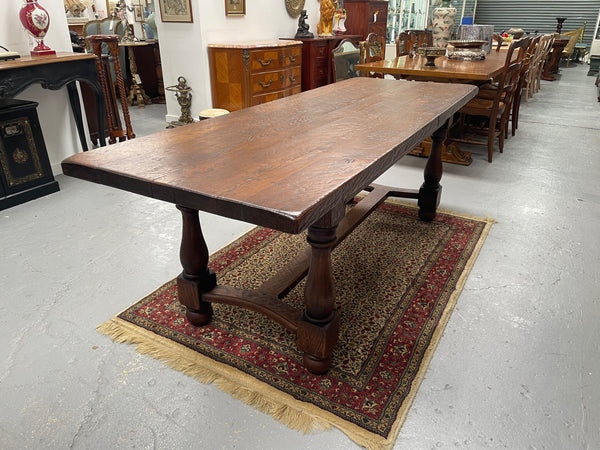 Solid charming rustic French farmhouse table with a stretcher base and turned legs. Imported directly from France and is circa 1930's. In good original detailed condition.