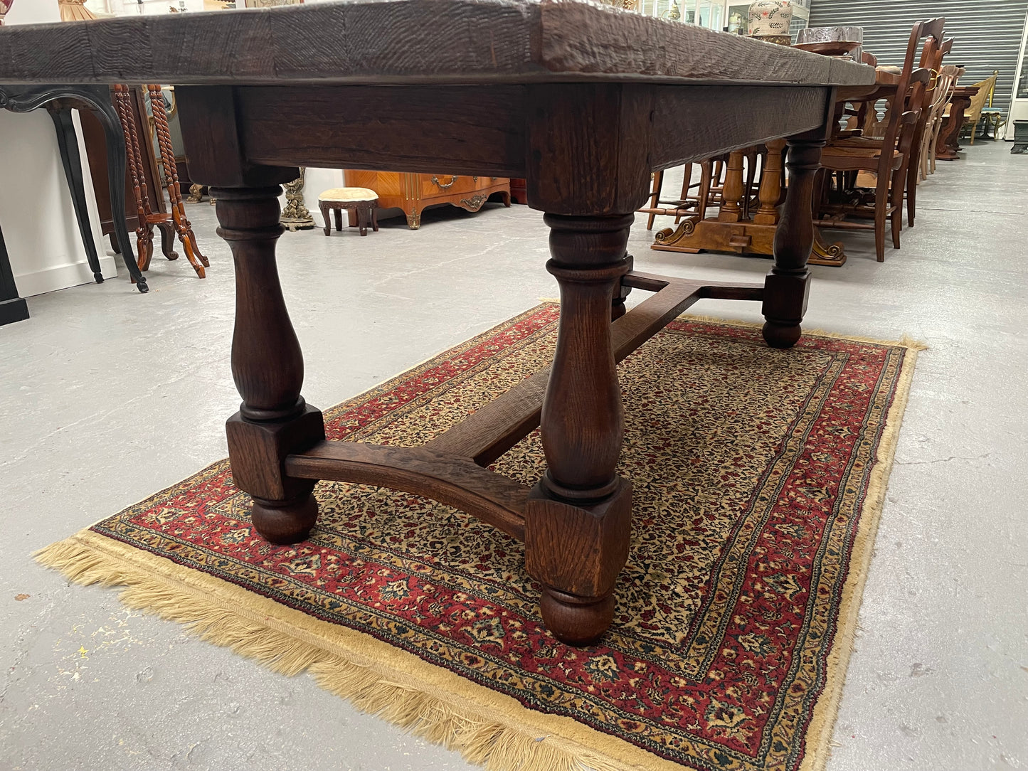 Solid charming rustic French farmhouse table with a stretcher base and turned legs. Imported directly from France and is circa 1930's. In good original detailed condition.