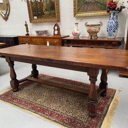 Solid charming rustic French farmhouse table with a stretcher base and turned legs. Imported directly from France and is circa 1930's. In good original detailed condition.