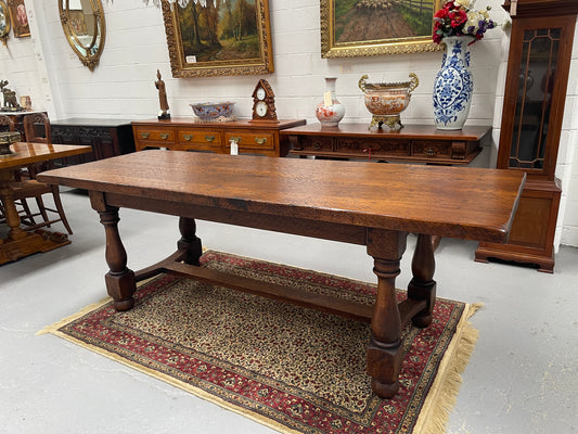 Solid charming rustic French farmhouse table with a stretcher base and turned legs. Imported directly from France and is circa 1930's. In good original detailed condition.