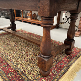 Solid charming rustic French farmhouse table with a stretcher base and turned legs. Imported directly from France and is circa 1930's. In good original detailed condition.