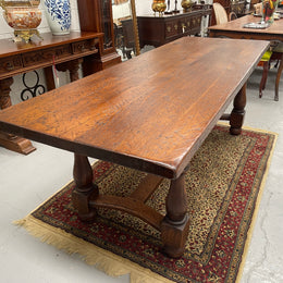 Solid charming rustic French farmhouse table with a stretcher base and turned legs. Imported directly from France and is circa 1930's. In good original detailed condition.