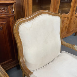 Pair of vintage Louis 15th style oak framed bergeres chairs with good size seats. making them very comfortable to sit in. The upholstery is in used condition with stains as shown in photos. Overall the timber frames are strong &amp; solid. They have been sourced directly from France. 