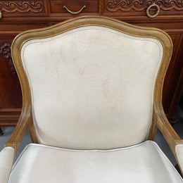 Pair of vintage Louis 15th style oak framed bergeres chairs with good size seats. making them very comfortable to sit in. The upholstery is in used condition with stains as shown in photos. Overall the timber frames are strong &amp; solid. They have been sourced directly from France. 