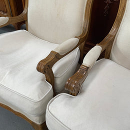 Pair of vintage Louis 15th style oak framed bergeres chairs with good size seats. making them very comfortable to sit in. The upholstery is in used condition with stains as shown in photos. Overall the timber frames are strong &amp; solid. They have been sourced directly from France. 