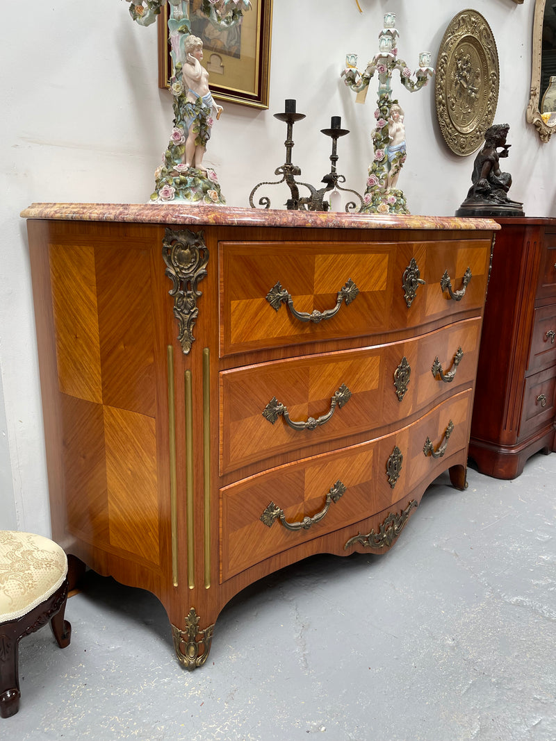 Appealing French Louis XIV style three drawer inlaid marble top commode. It has a stunning marble top and attractive ormolu trims. In good original detailed condition.