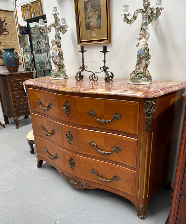 Appealing French Louis XIV style three drawer inlaid marble top commode. It has a stunning marble top and attractive ormolu trims. In good original detailed condition.