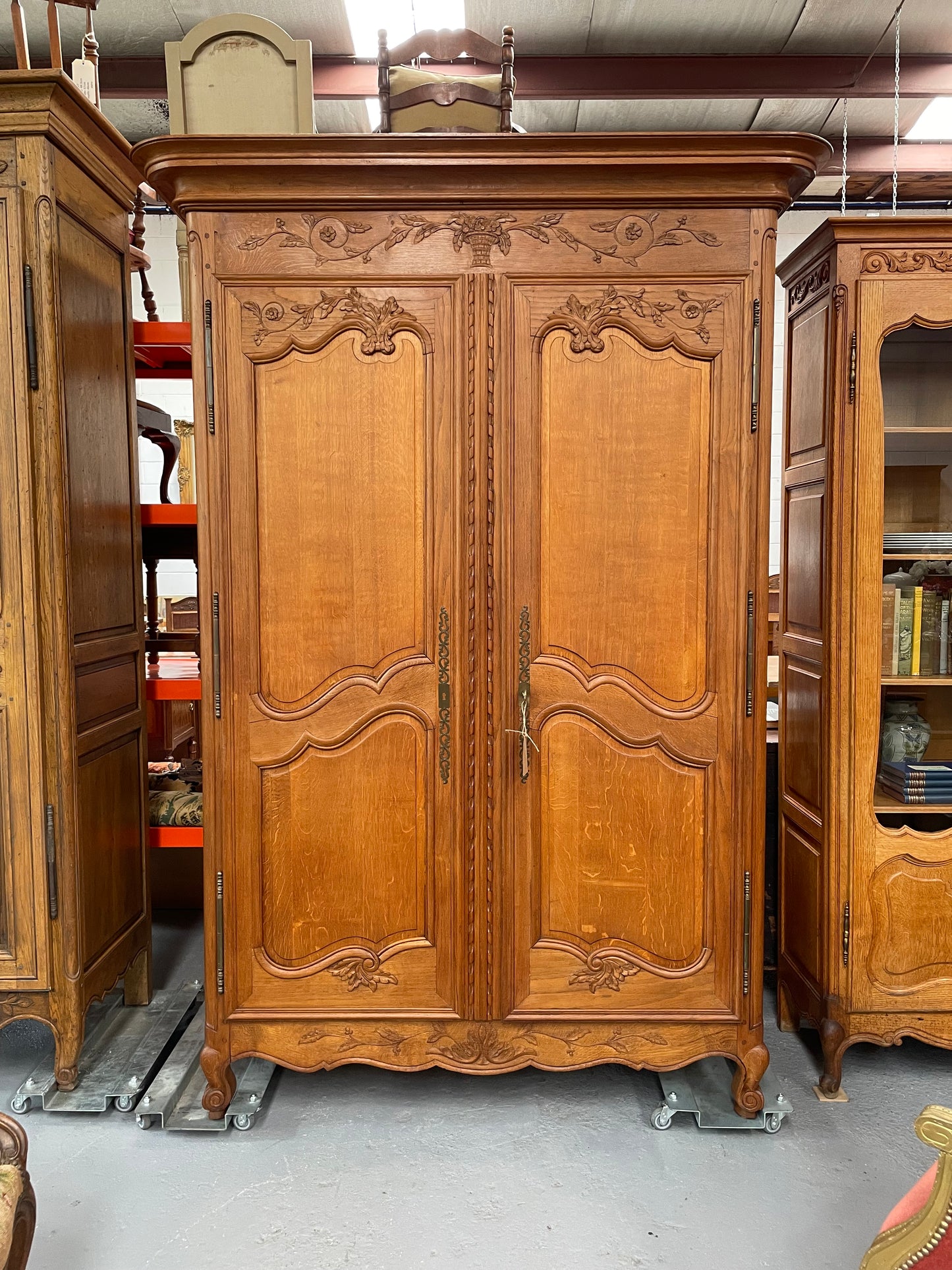 This attractive two door armoire has full hanging space. It is a pleasing piece with fine decorative carvings on the doors and is known as a marriage armoire. Imported directly from France and is in good original detailed condition.