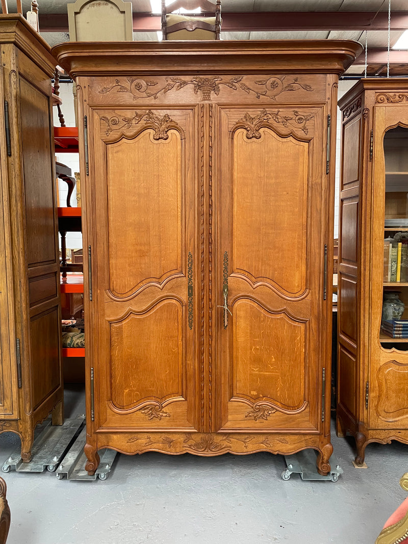 This attractive two door armoire has full hanging space. It is a pleasing piece with fine decorative carvings on the doors and is known as a marriage armoire. Imported directly from France and is in good original detailed condition.