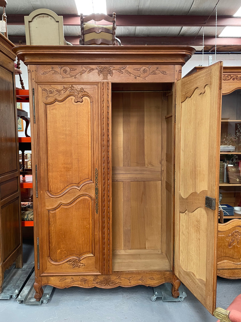 This attractive two door armoire has full hanging space. It is a pleasing piece with fine decorative carvings on the doors and is known as a marriage armoire. Imported directly from France and is in good original detailed condition.