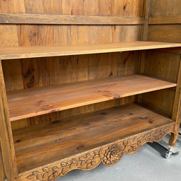 Attractive French Oak two door decoratively carved armoire with hanging space and adjustable/removable shelves. Imported directly from France and is in good original detailed condition. 