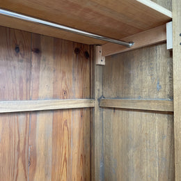 Attractive French Oak two door decoratively carved armoire with hanging space and adjustable/removable shelves. Imported directly from France and is in good original detailed condition. 
