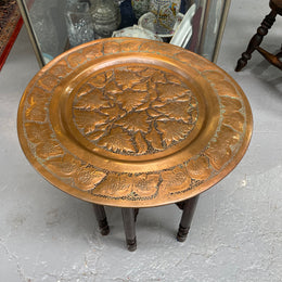 Middle eastern carved folding bases coffee table. It has a copper top intricately pierced and patterned. It is in good original condition. Please see photos as they form part of the description and condition.
