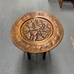 Middle eastern carved folding bases coffee table. It has a copper top intricately pierced and patterned. It is in good original condition. Please see photos as they form part of the description and condition.