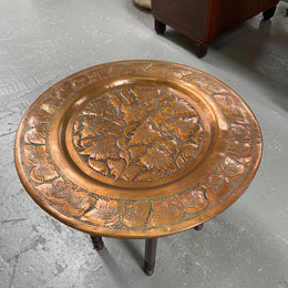 Middle eastern carved folding bases coffee table. It has a copper top intricately pierced and patterned. It is in good original condition. Please see photos as they form part of the description and condition.