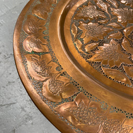 Middle eastern carved folding bases coffee table. It has a copper top intricately pierced and patterned. It is in good original condition. Please see photos as they form part of the description and condition.