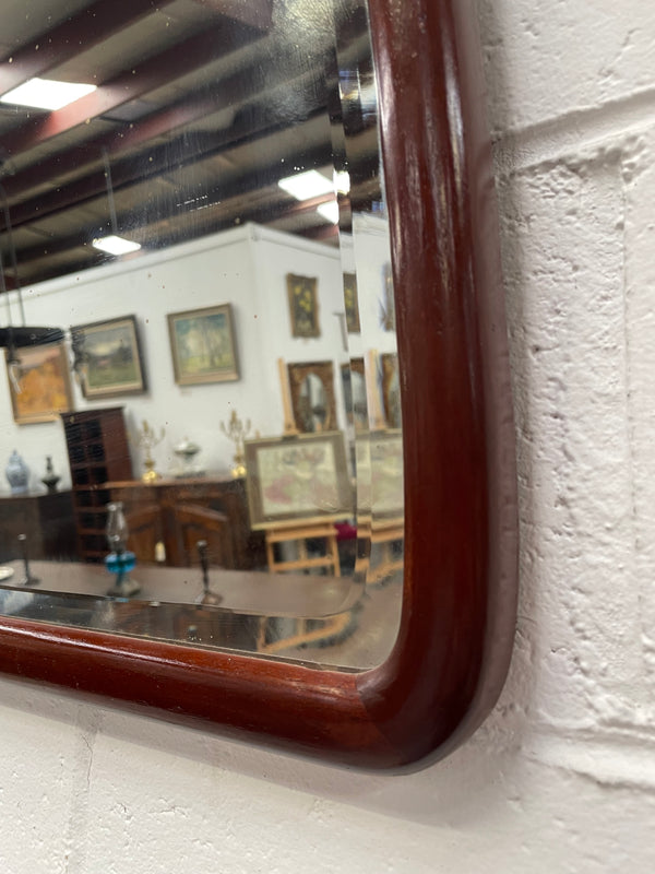 Large Mahogany framed bevelled edge wall mirror. In good original condition.