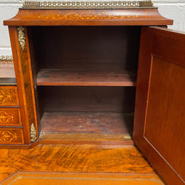 A very attractive burr walnut writing desk (Bonheur De Jour) with ormolu mounts throughout. The boxwood inlaid decoration is featured on the drawers and the mirrored cupboard which also feature brass galleries. The table area features burr walnut and a tooled leather inlay. A long drawer underneath features further inlay and stringing and all have lovely ormolu handles. It is a stunning piece of furniture of fantastic quality and makes a good ladies writing desk. In very good condition.