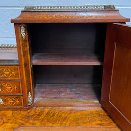 A very attractive burr walnut writing desk (Bonheur De Jour) with ormolu mounts throughout. The boxwood inlaid decoration is featured on the drawers and the mirrored cupboard which also feature brass galleries. The table area features burr walnut and a tooled leather inlay. A long drawer underneath features further inlay and stringing and all have lovely ormolu handles. It is a stunning piece of furniture of fantastic quality and makes a good ladies writing desk. In very good condition.