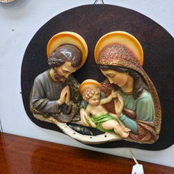 Angled view of vintage polychrome Holy Family religious wall plaque